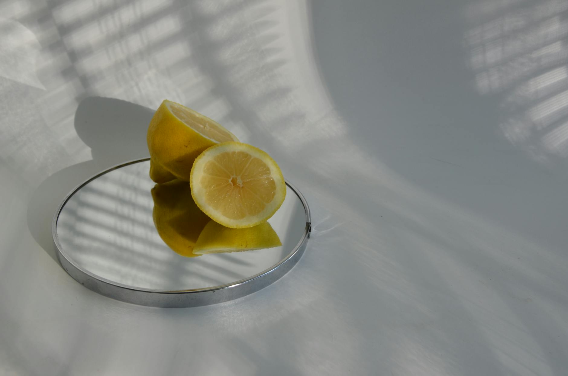 Bright yellow lemons on a pastel green background, representing the fresh, accessible design of the Lem by Lems Nancy