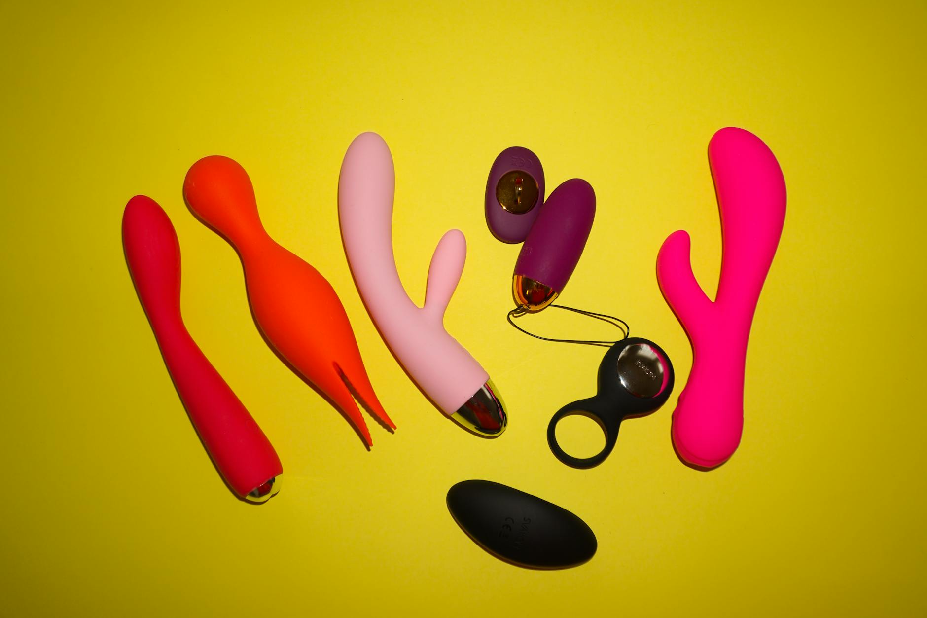 Blue lemon vibrator surrounded by fresh citrus fruit and flowers on vibrant yellow background